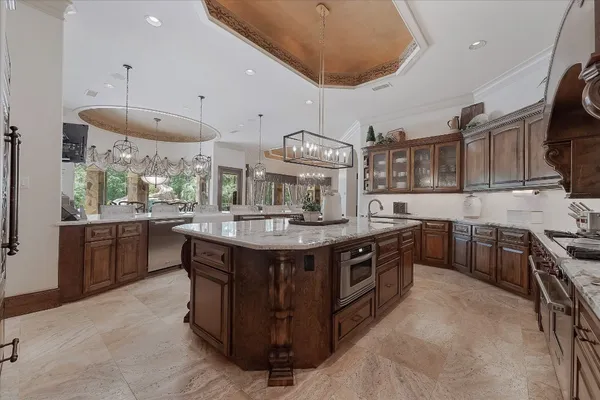 a kitchen with stainless steel appliances granite countertop a stove a sink and a refrigerator