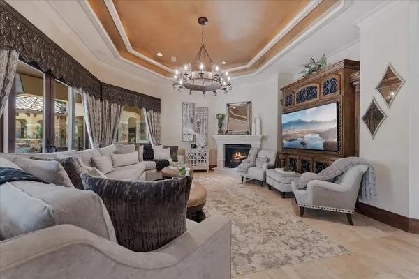 a living room with furniture a fireplace and a large mirror