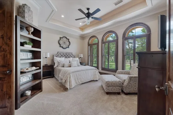 a bedroom with furniture and a large window