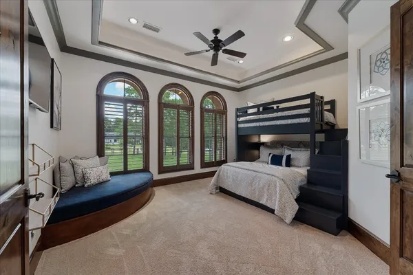 a living room with a bed furniture and a large window