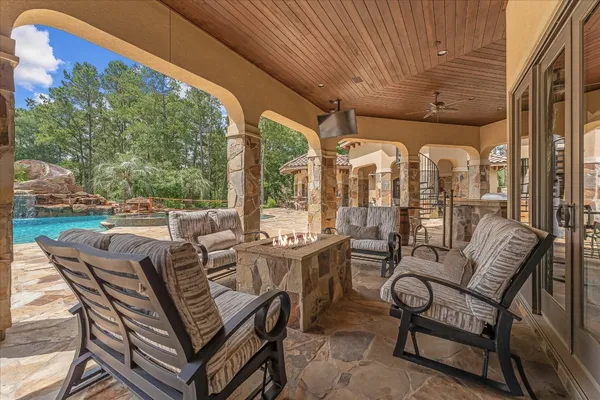 a view of a patio with dining table and chairs