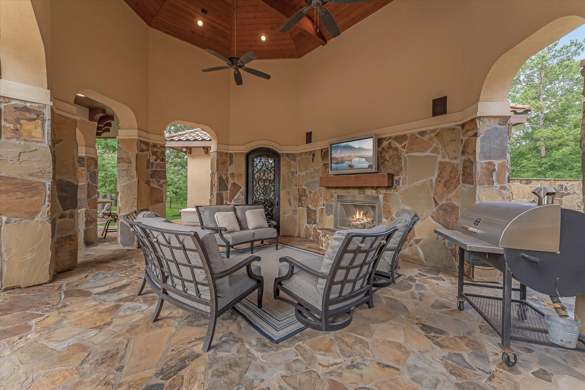 28322 Meadow Forest Magnolia, TX 77355 - Photo 41 of 50 The Guest House features two guest suites, each with an ensuite bathroom. Both ensuites include a shower, a walk-in closet with pocket doors, and granite countertop coffee bars equipped with refrigerators with cabinet façades. A third full bath is located by the custom arched iron entry door, adjacent to that is the utility room equipped with full-size washer and dryer units beneath countertops, cabinets, and an additional refrigerator.