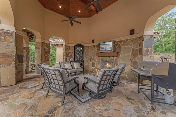 a view of a patio with dining table and chairs with wooden floor
