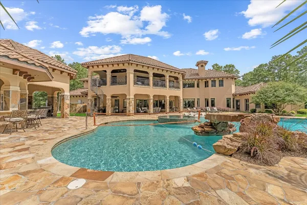 a view of a house with a backyard porch and sitting area