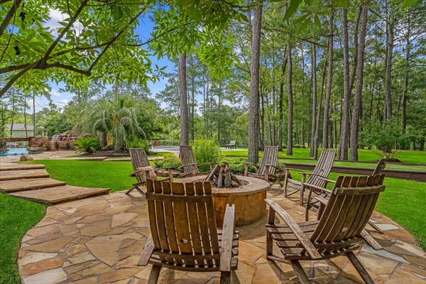 a view of a patio with a table chairs and a backyard