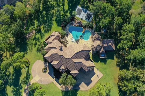 an aerial view of a house with a yard