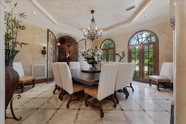 a view of a dining room with furniture and a chandelier