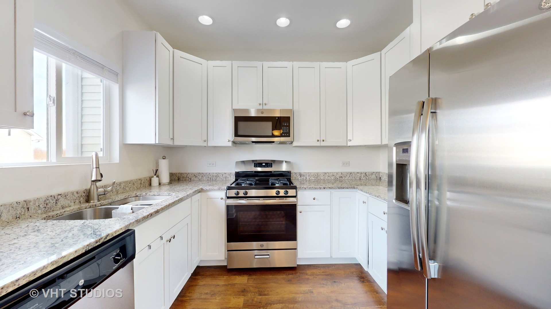 1924 Rena Lane Yorkville, IL 60560 - Photo 6 of 29 a kitchen with a stove a sink and a refrigerator