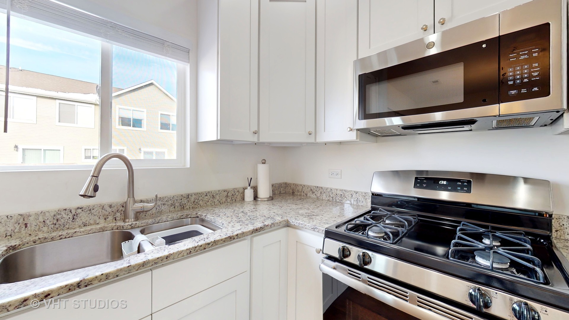 1924 Rena Lane Yorkville, IL 60560 - Photo 8 of 29 a kitchen with stainless steel appliances granite countertop a sink a stove and a microwave