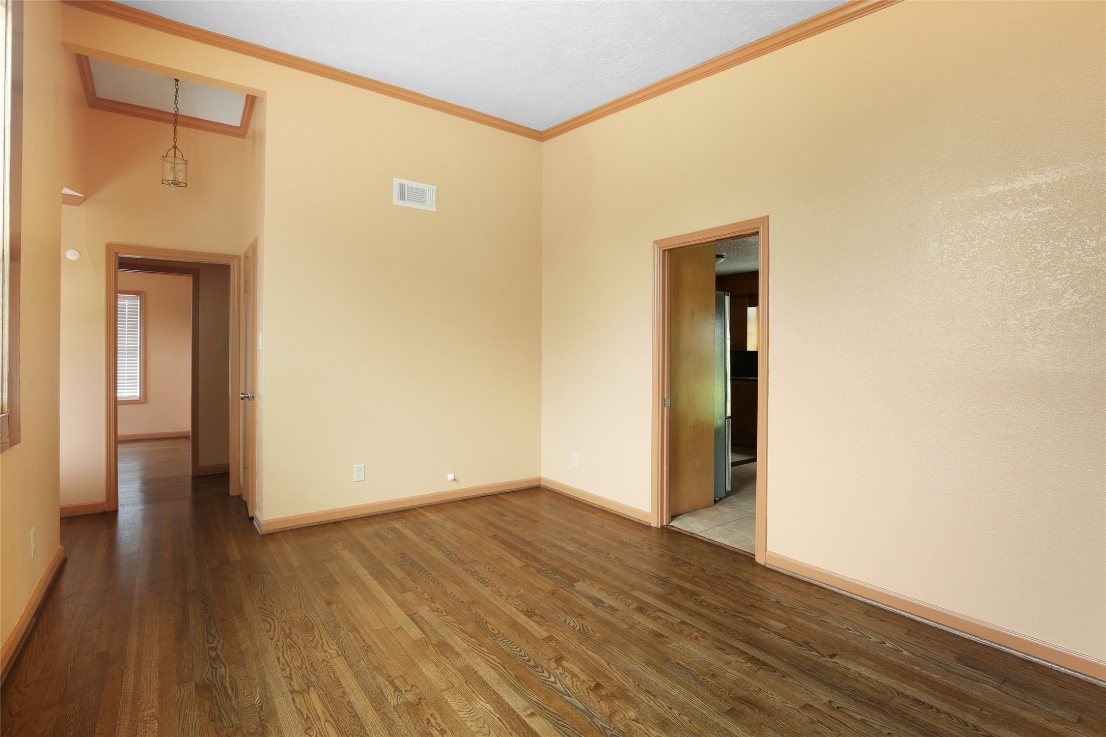 6923 Leader Street Houston, TX 77074 - Photo 3 of 19 a view of an empty room with wooden floor and a window