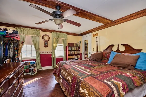 a bedroom with a bed a dresser and book shelf