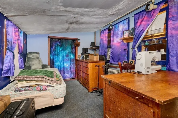 a bedroom with bed and cabinets