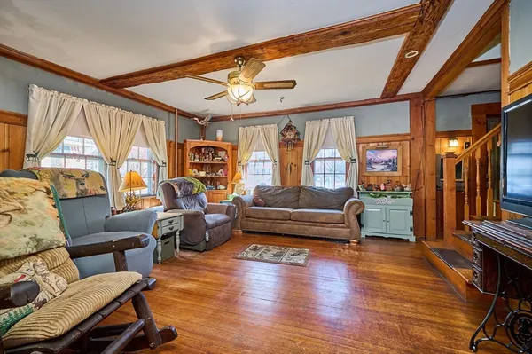 a living room with furniture a fireplace and a large window