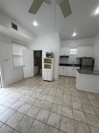 a kitchen with stainless steel appliances granite countertop a refrigerator and a stove top oven