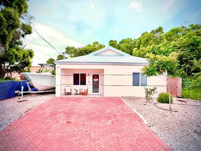 a front view of a house with a yard and sitting area