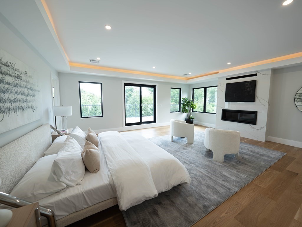 88 Levbert Road Newton, MA 02459 - Photo 17 of 41 a bedroom with furniture and a flat screen tv