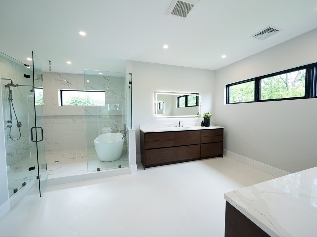 88 Levbert Road Newton, MA 02459 - Photo 20 of 41 a bathroom with a granite countertop sink mirror and vanity