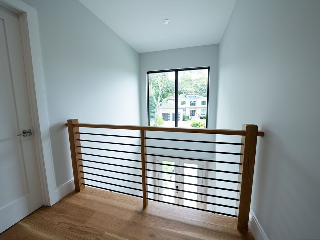 88 Levbert Road Newton, MA 02459 - Photo 24 of 41 a view of a bedroom with wooden floor and windows