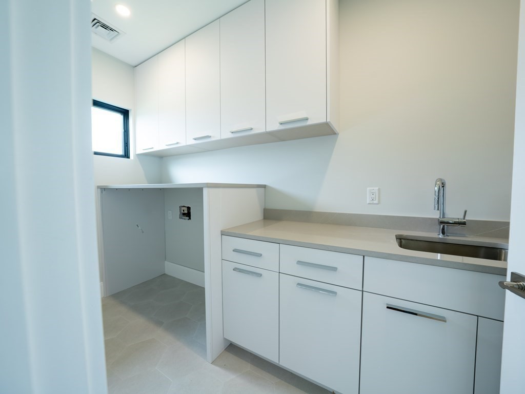 88 Levbert Road Newton, MA 02459 - Photo 26 of 41 a kitchen with white cabinets