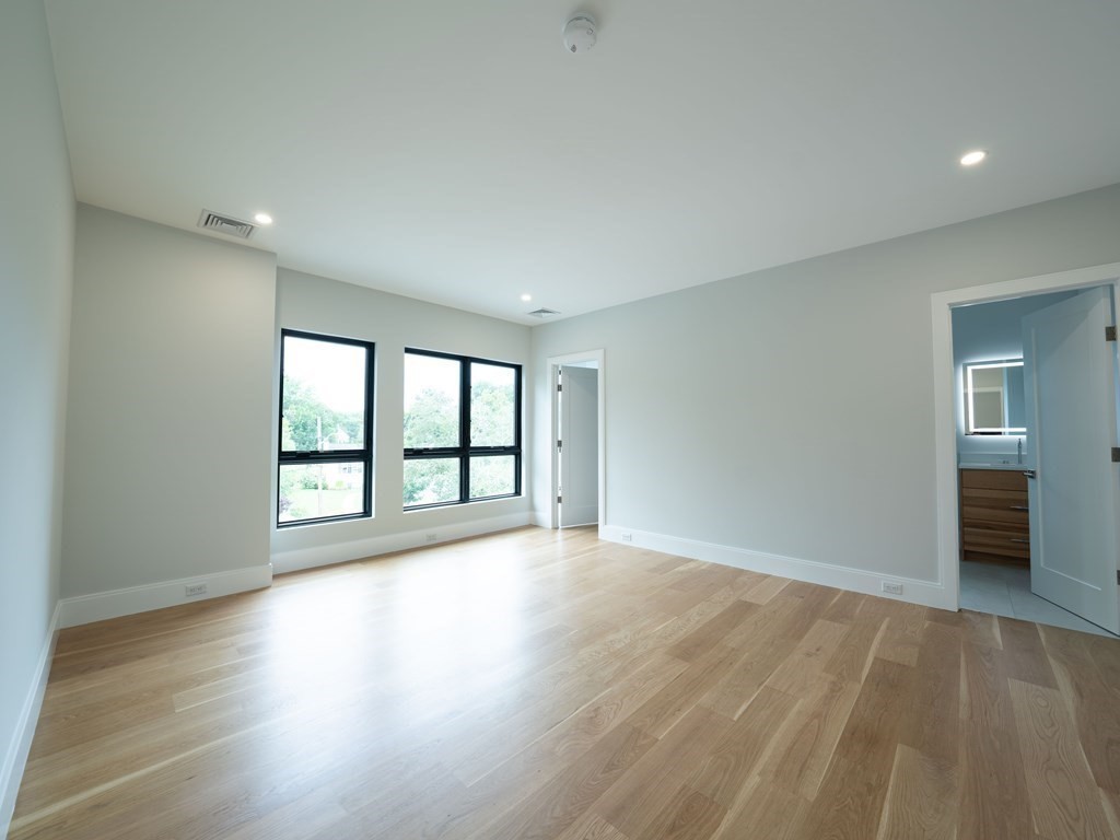 88 Levbert Road Newton, MA 02459 - Photo 27 of 41 a view of an empty room with wooden floor and a window