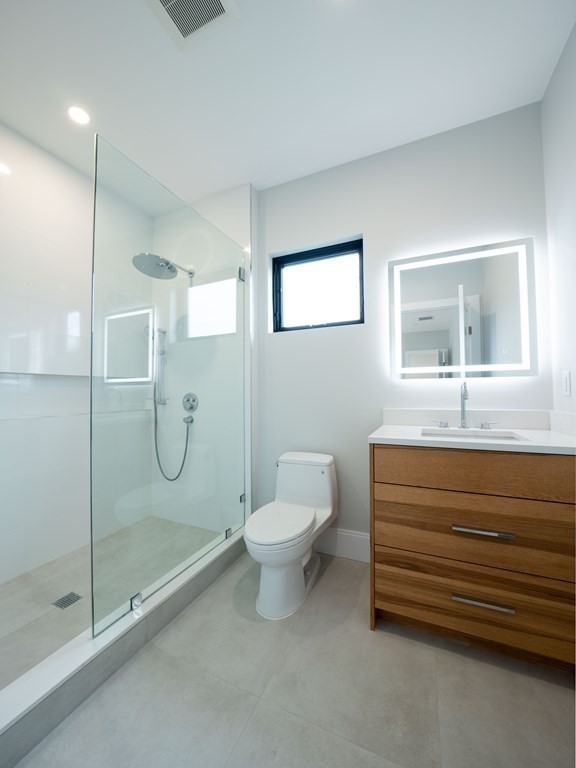 88 Levbert Road Newton, MA 02459 - Photo 28 of 41 a bathroom with a shower sink mirror and toilet