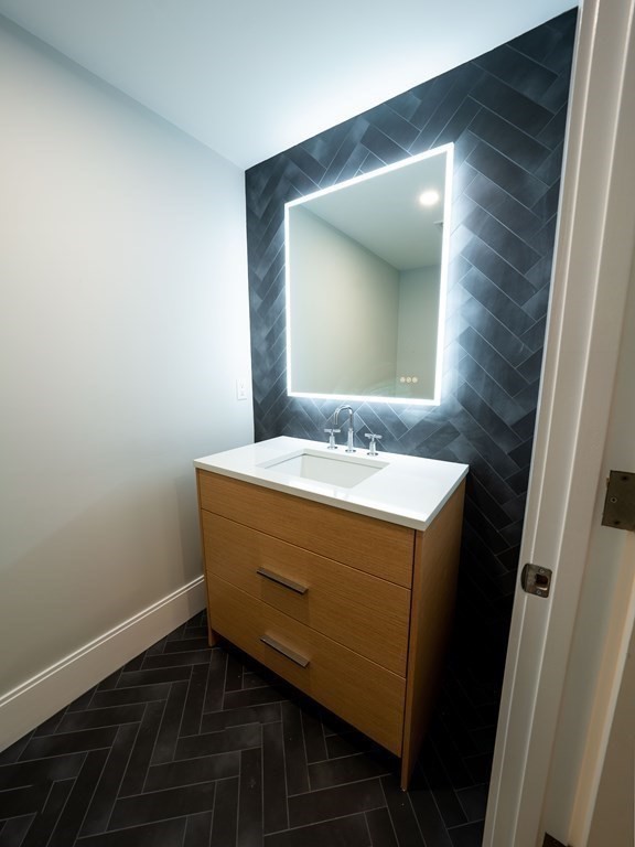 88 Levbert Road Newton, MA 02459 - Photo 35 of 41 a bathroom with a sink and a mirror