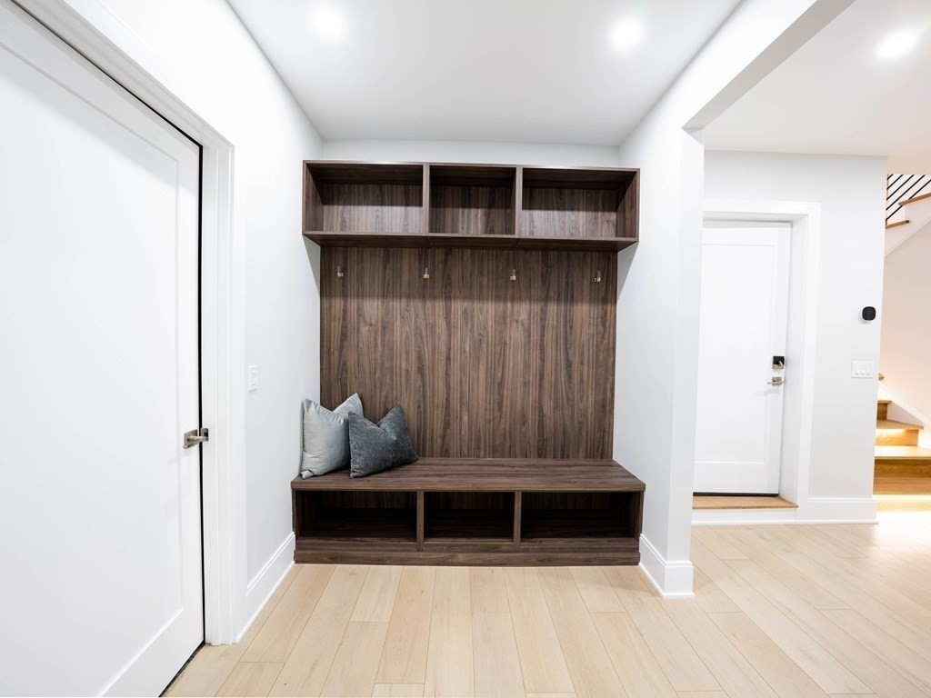 88 Levbert Road Newton, MA 02459 - Photo 36 of 41 a living room with a couch and a potted plant