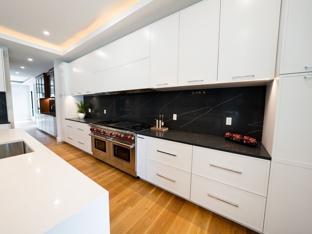 88 Levbert Road Newton, MA 02459 - Photo 9 of 41 a kitchen with stainless steel appliances white cabinets and a sink