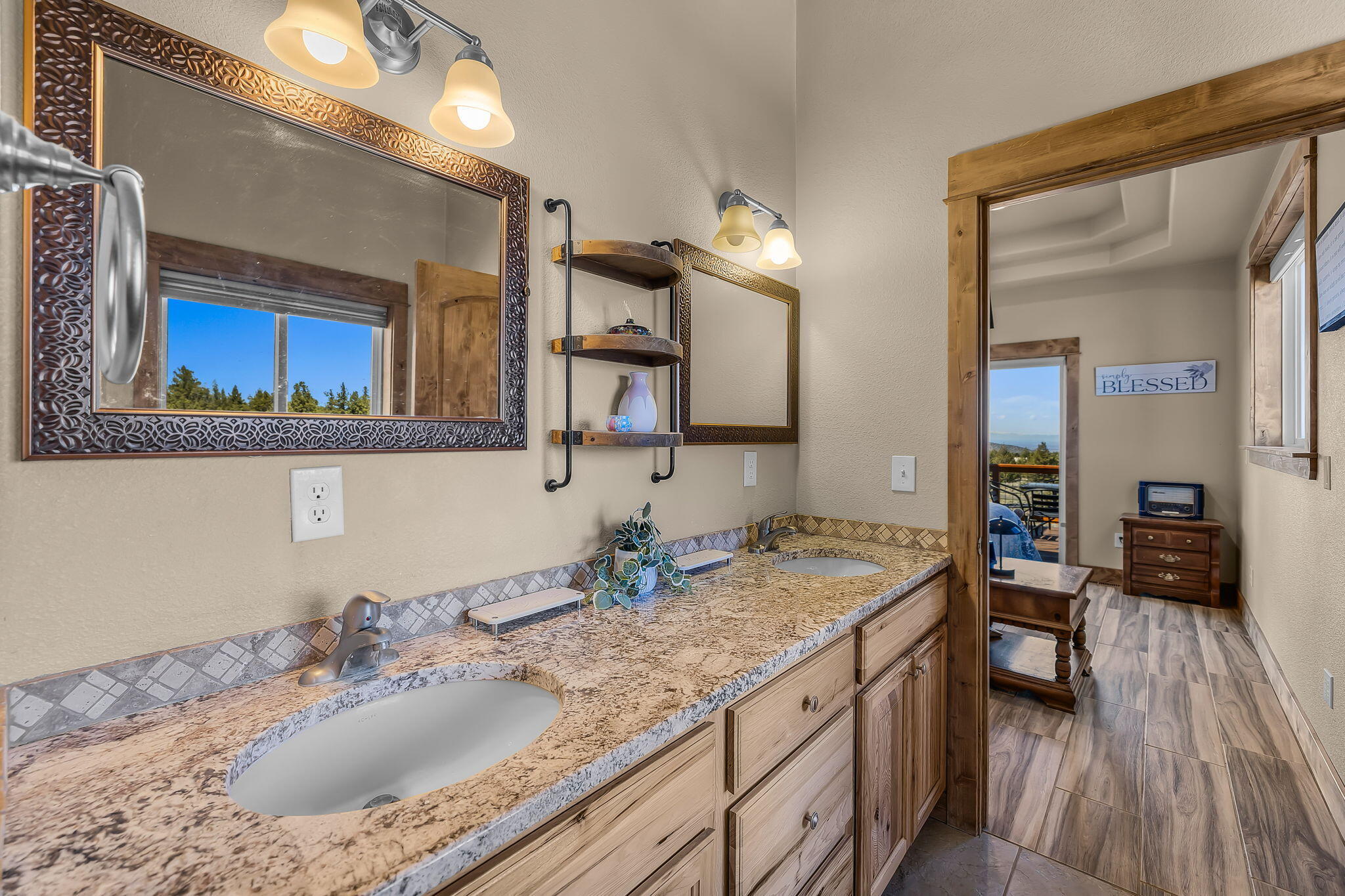 6040 Gravett Road Prineville, OR 97754 - Photo 22 of 77 a bathroom with a granite countertop sink a mirror and vanity