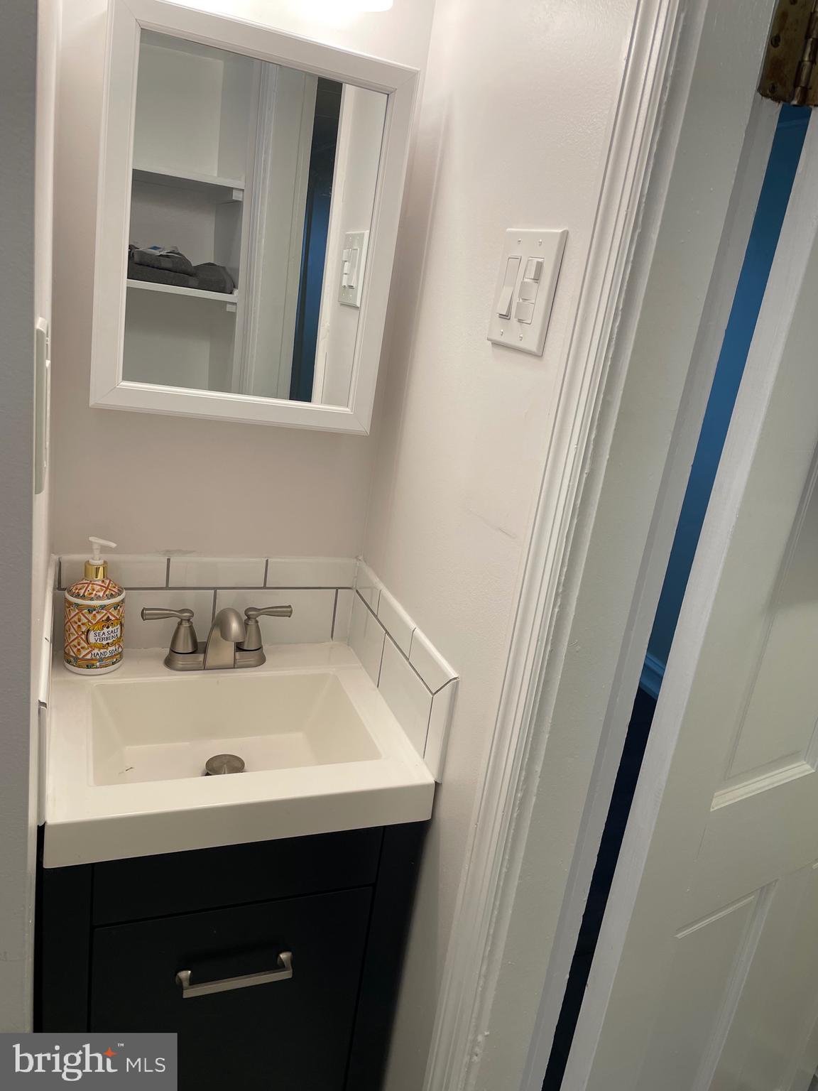 301 East Linden Street Moorestown, NJ 08057 - Photo 12 of 19 a bathroom with a sink and a mirror