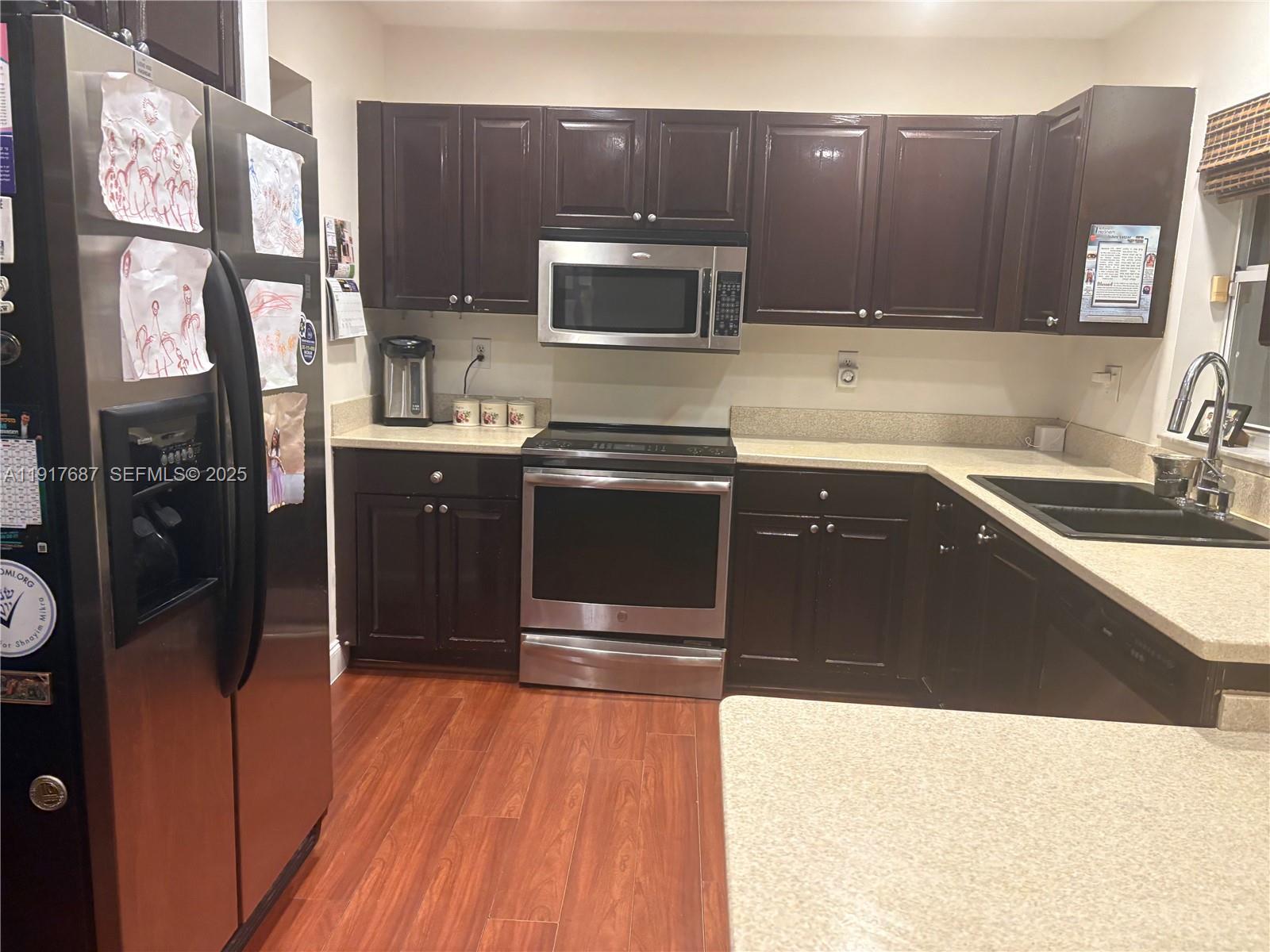 3195 North 36th Avenue Hollywood, FL 33021 - Photo 11 of 28 a kitchen with stainless steel appliances a stove a sink and a microwave