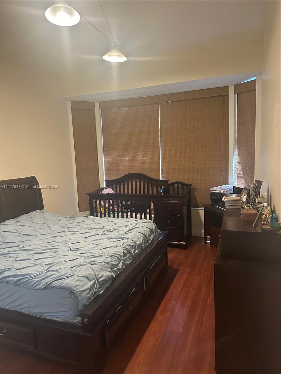 3195 North 36th Avenue Hollywood, FL 33021 - Photo 20 of 27 a bed sitting in a bedroom next to a window