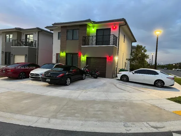 a view of a cars park in front of a building