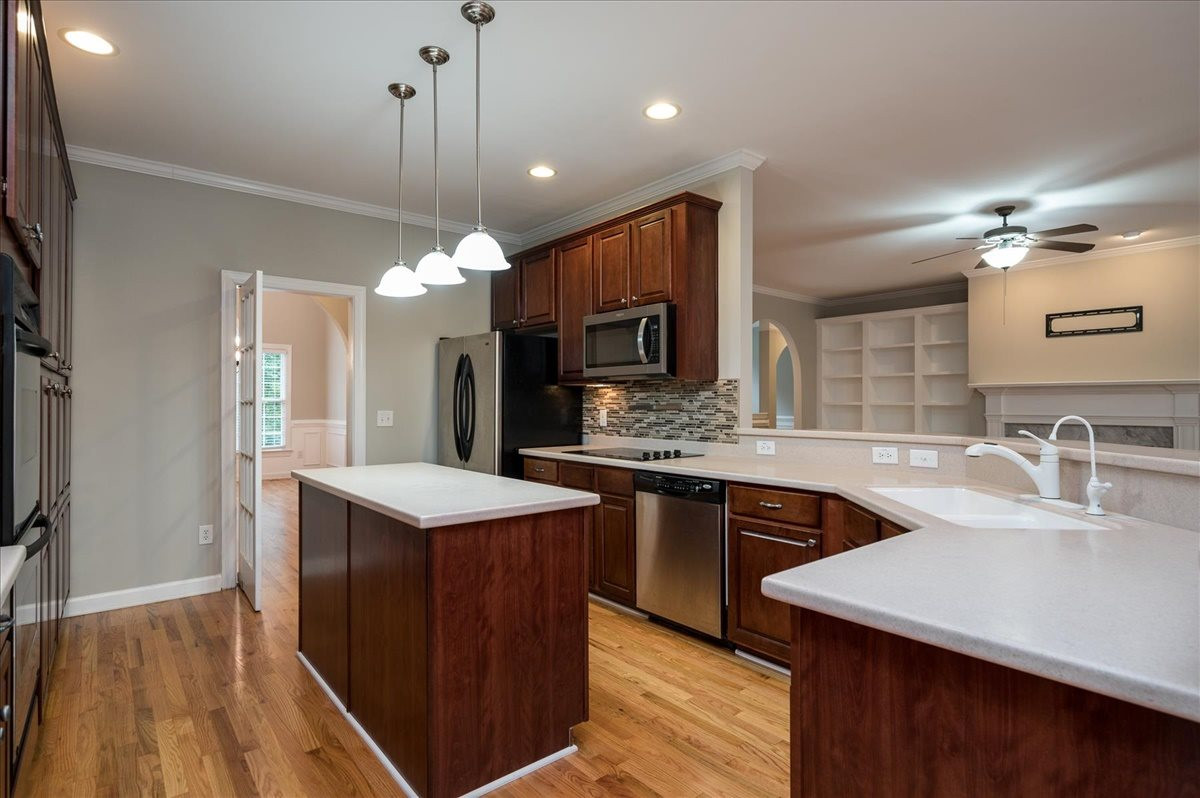 5245 Bartons Enclave Lane Raleigh, NC 27613 - Photo 5 of 27 Enjoy Peninsula seating at the bar for 4 .. All open and inviting to Family Room and Breakfast Room. Kitchen features swing door that leads to hall Butlers Pantry and Dining Room Kitchen