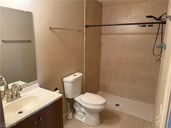 a white toilet sitting next to a bathroom sink