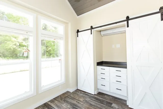 a view of walk in closet with hardwood