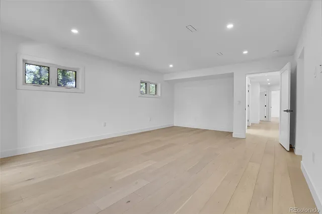 a bathroom with a granite countertop sink a toilet and a mirror