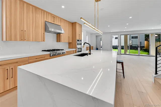 a room with gym equipment and wooden floor