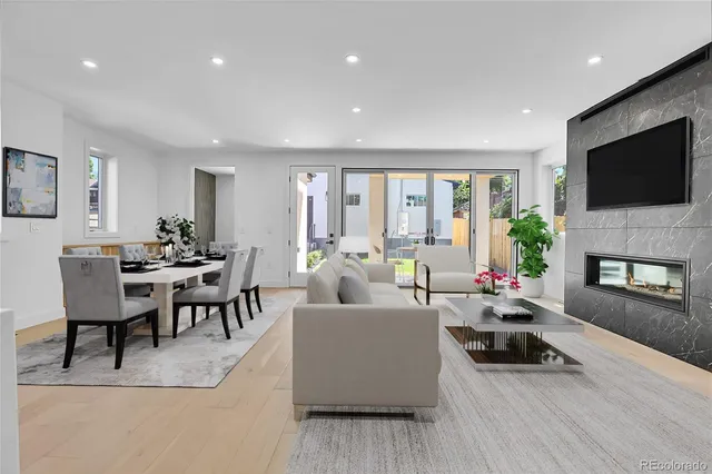 a living room with fireplace furniture and a flat screen tv