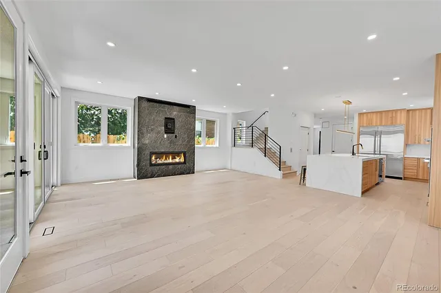 a view of a kitchen with wooden floor and electronic appliances
