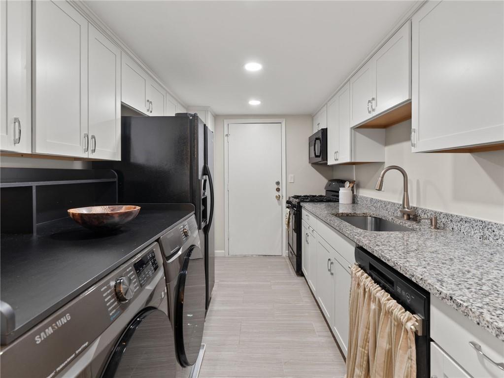6851 Roswell Road, Unit H26 Atlanta, GA 30328 - Photo 9 of 49 a kitchen with stainless steel appliances granite countertop a sink stove and refrigerator