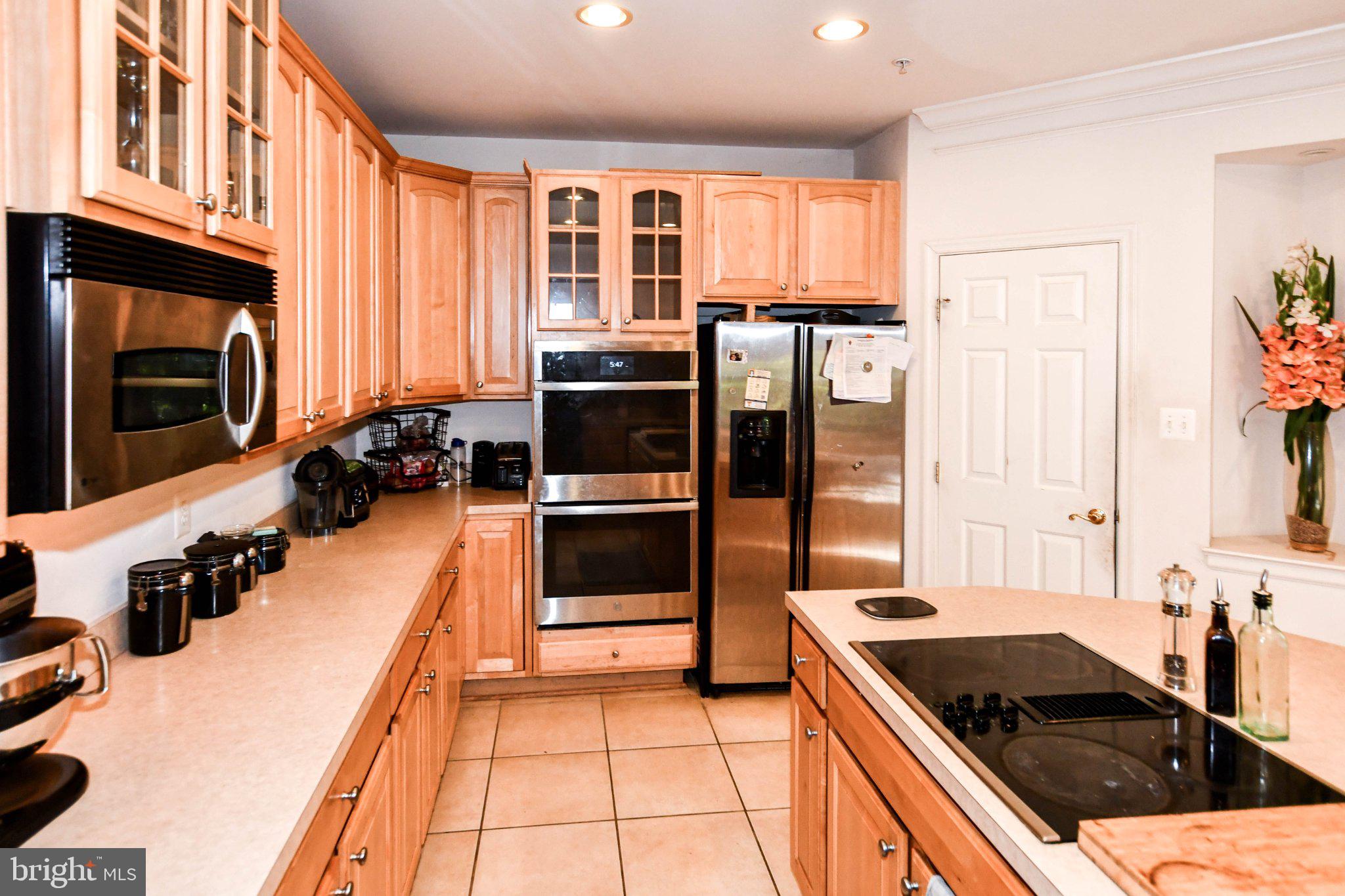 3208 Clavier Place Clinton, MD 20735 - Photo 22 of 55 Modern kitchen with warm wood tones.