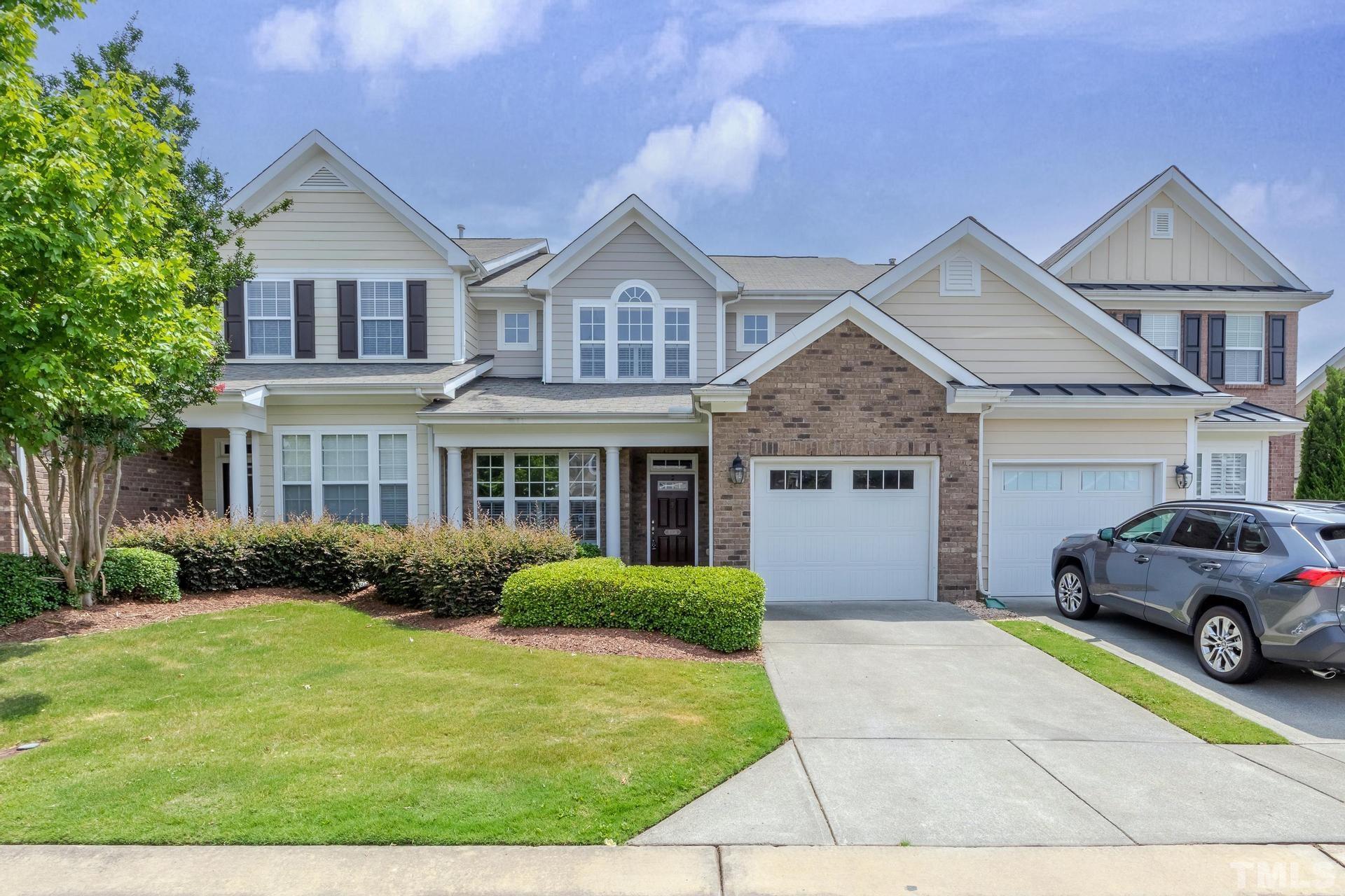 10114 Falls Meadow Court Raleigh, NC 27617 - Photo 1 of 53 a front view of a house with a garden