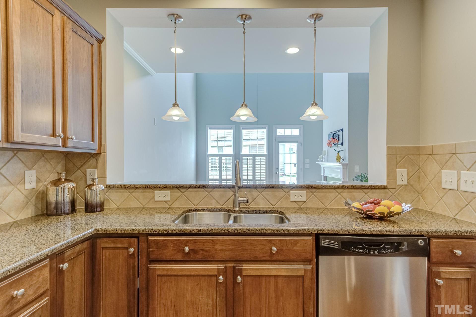 10114 Falls Meadow Court Raleigh, NC 27617 - Photo 20 of 53 a kitchen with a sink cabinets and wooden floor
