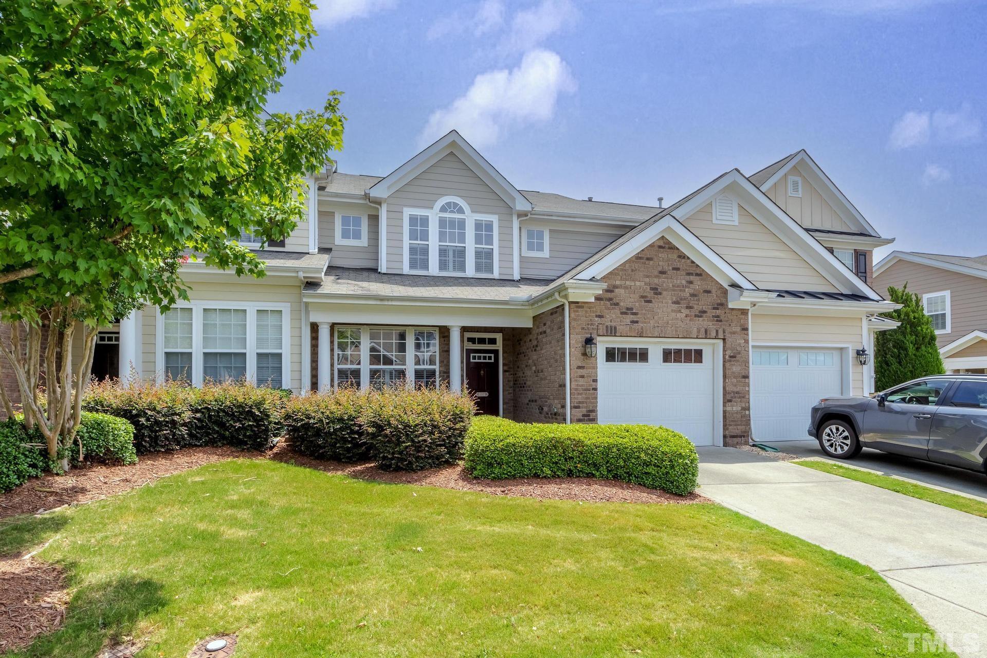 10114 Falls Meadow Court Raleigh, NC 27617 - Photo 2 of 53 a front view of a house with garden