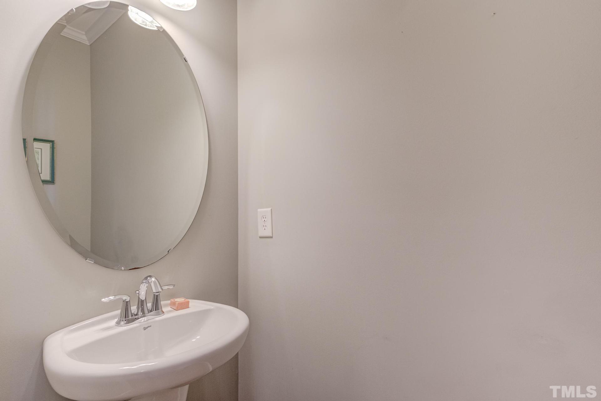 10114 Falls Meadow Court Raleigh, NC 27617 - Photo 24 of 53 a bathroom with a sink and mirror