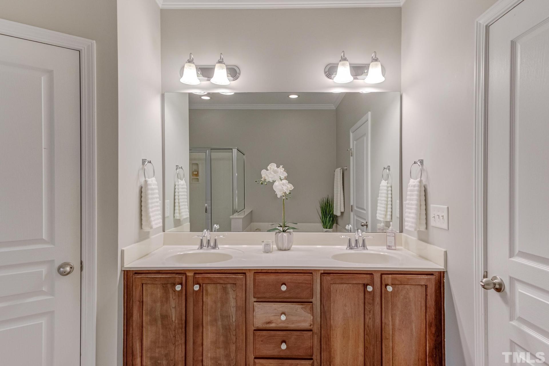 10114 Falls Meadow Court Raleigh, NC 27617 - Photo 31 of 53 a bathroom with a double vanity sink and a mirror