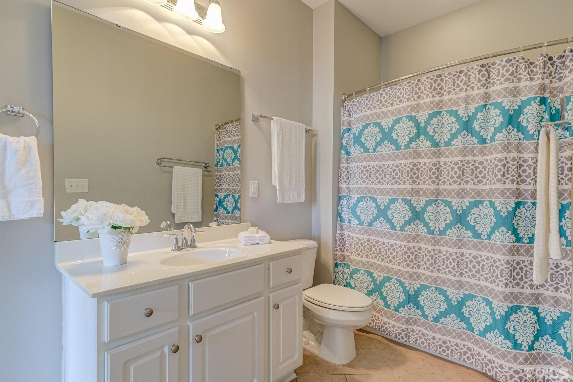 10114 Falls Meadow Court Raleigh, NC 27617 - Photo 35 of 53 a bathroom with a sink mirror vanity and toilet
