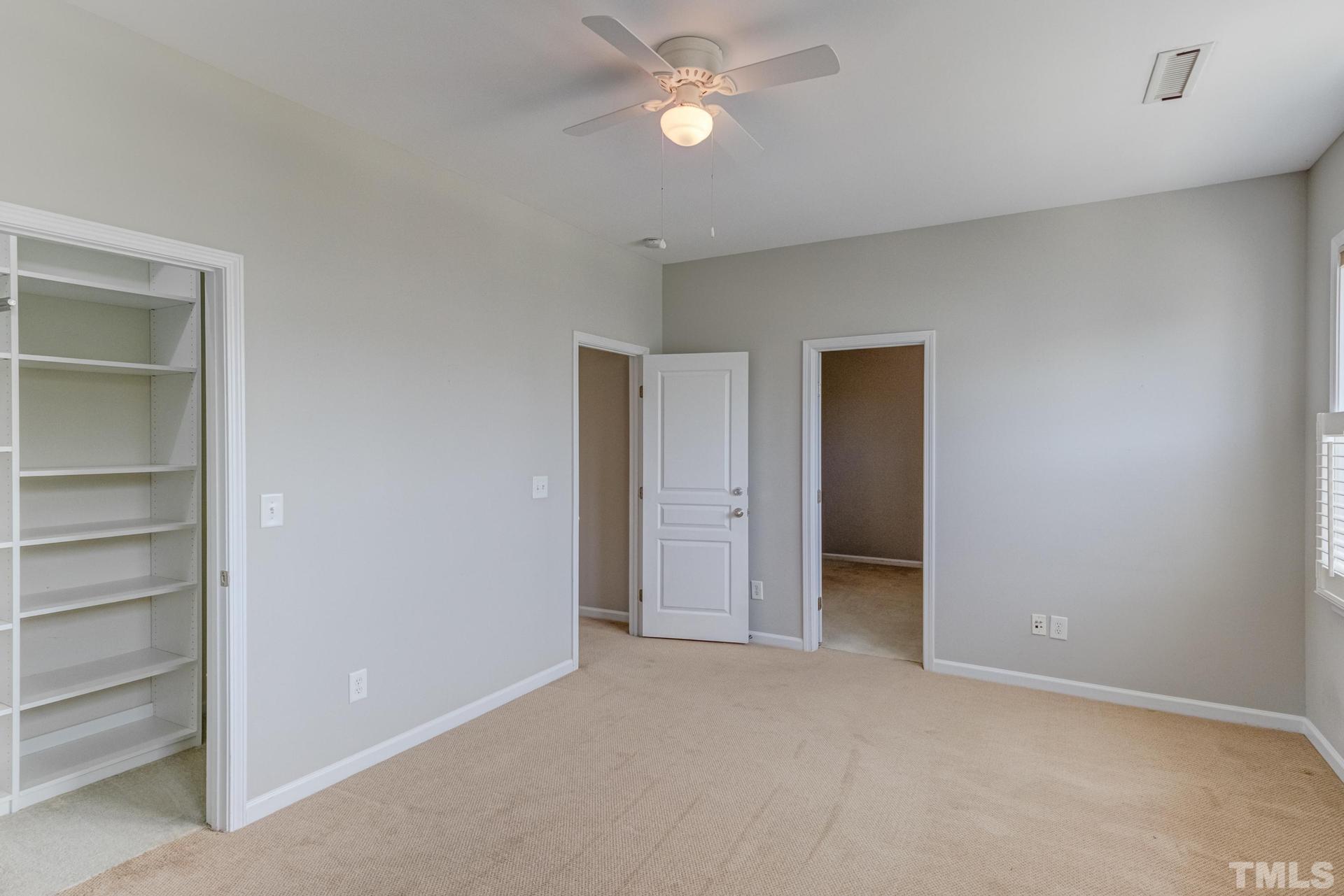 10114 Falls Meadow Court Raleigh, NC 27617 - Photo 42 of 53 a view of an empty room with a ceiling fan