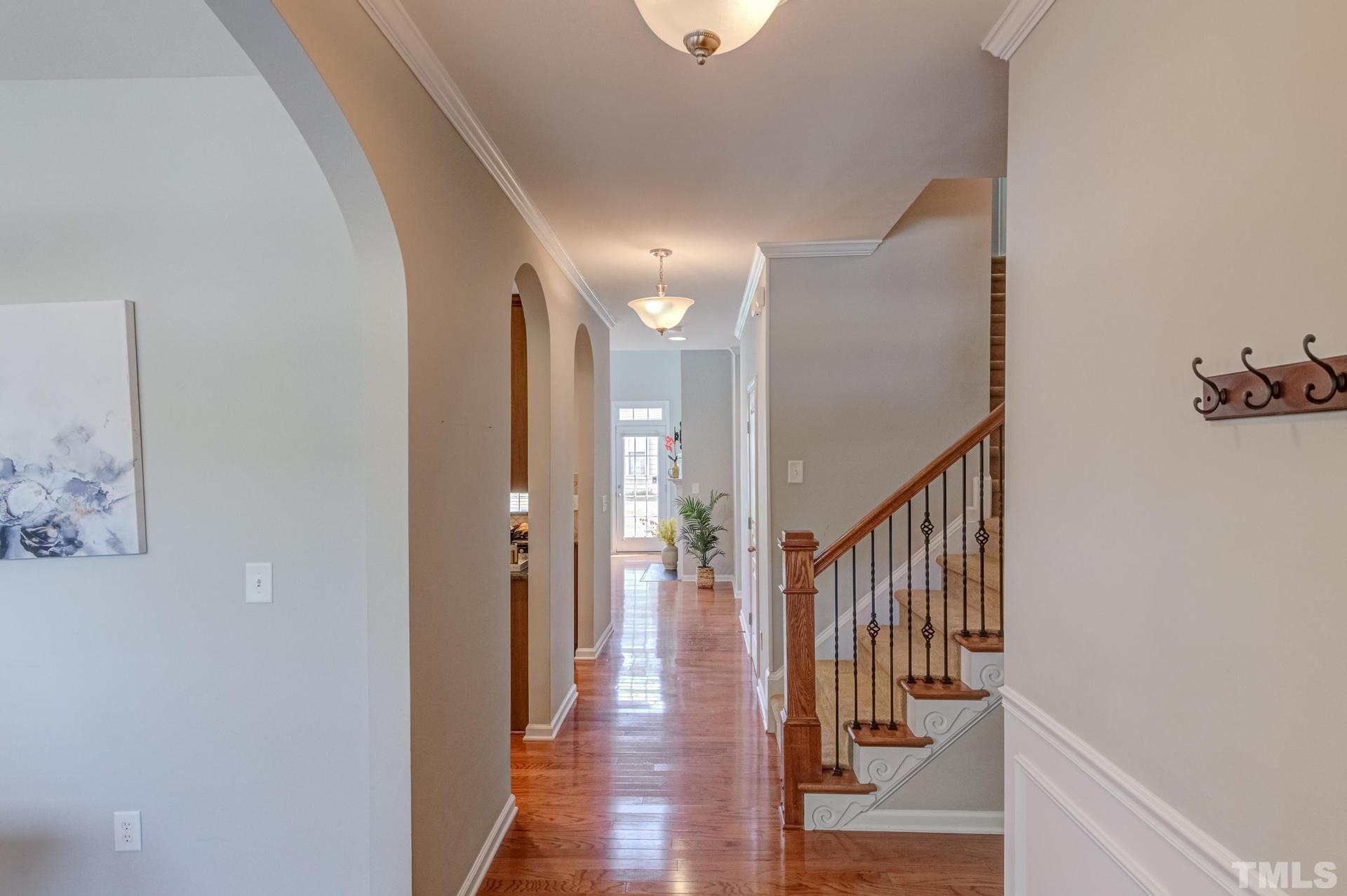 10114 Falls Meadow Court Raleigh, NC 27617 - Photo 7 of 53 a view of a hallway with wooden floor and stairs